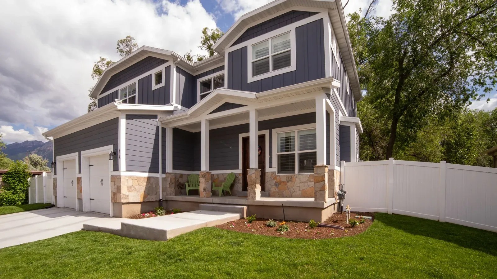 Freshly painted blue-grey two-storey home with white trim